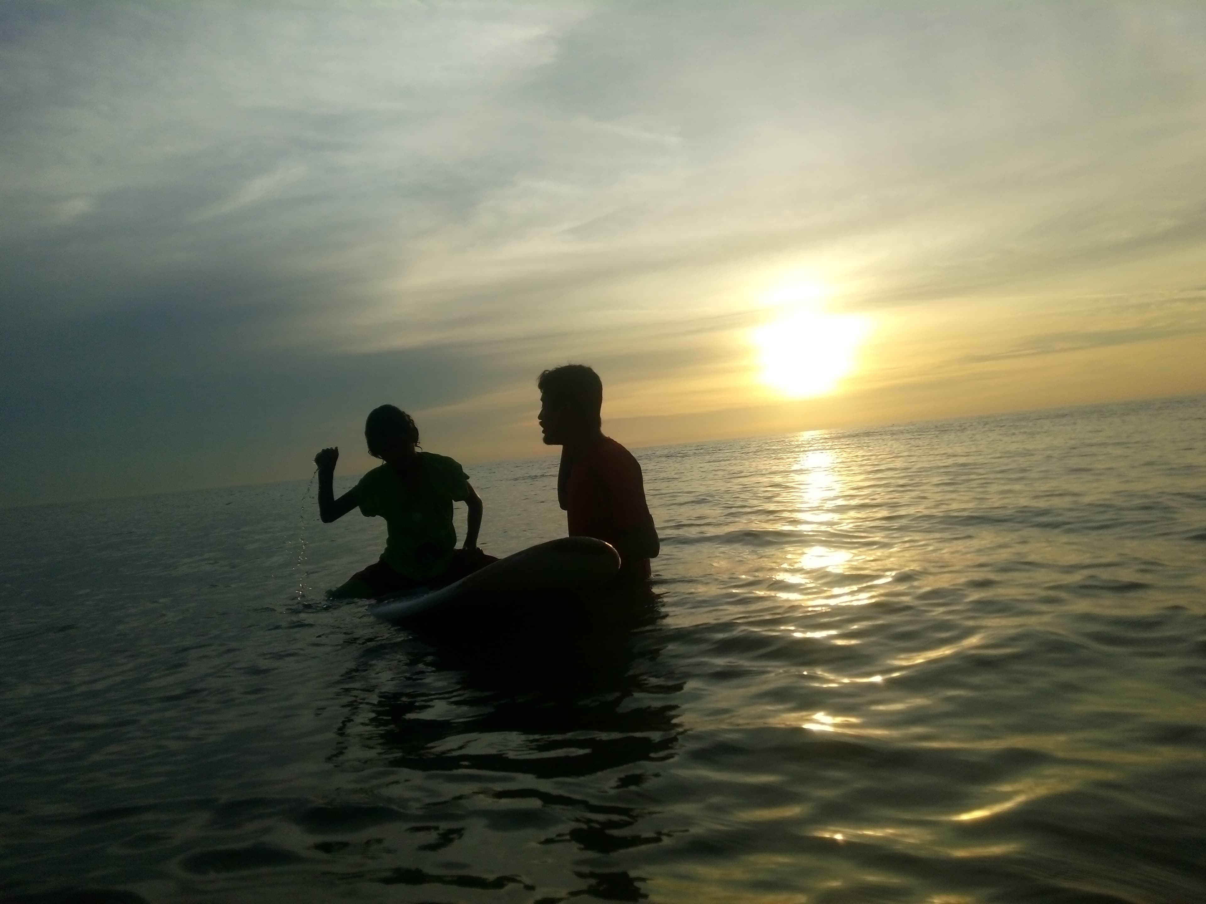 Surfing at golden sunset